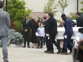 Michael Ciasullo  (L) watches as the casket of his daughter Lilianna is led into St. Eugene De Mazenod Catholic Church in Brampton. His wife Karolina and their three daughters Klara, Mila and Lilianna who were killed last Thursday arrive at the church for the funeral service.