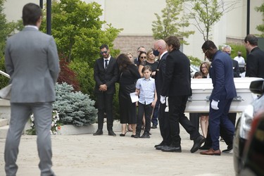 Michael Ciasullo  (L) watches as the casket of his daughter Lilianna is led into St. Eugene De Mazenod Catholic Church in Brampton. His wife Karolina and their three daughters Klara, Mila and Lilianna who were killed last Thursday arrive at the church for the funeral service.