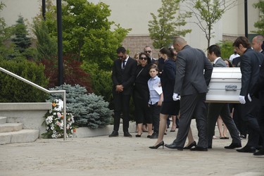 Michael Ciasullo  (L) watches as the casket of his daughter Klara is led into St. Eugene De Mazenod Catholic Church in Brampton. His wife Karolina and their three daughters Klara, Mila and Lilianna who were killed last Thursday arrive at the church for the funeral service  . Jack Boland/Toronto Sun/Postmedia Network
