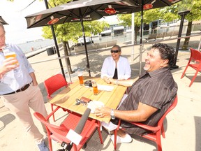 Toronto Mayor John Tory speaks with Milton Bernal and his wife Lisa, of Brampton, on the patio at Amsterdam BrewHouse on Queens Quay W.