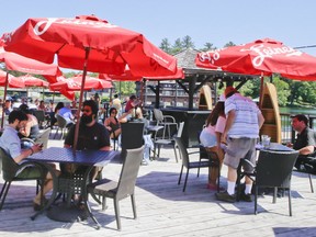 Patrons enjoy an outdoor patio at Turtle Jacks' as Port Carling welcomes tourist back to the area after the Muskoka area enters stage two of lifting the COVID-19 lockdown on Thursday, June 18, 2020.