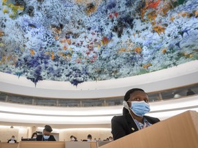 A delegate from Angola attends the United Nations Human Rights Council on June 19, 2020 in Geneva during the vote of a watered-down resolution condemning structural racism and police brutality in the wake of the death of George Floyd. - The UN's top human rights body adopted a resolution condemning structural racism and police brutality, after the text was revised to remove specific mention of the United States.