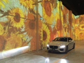 A car makes its way through the Immersive Van Gogh art exhibit in Toronto.