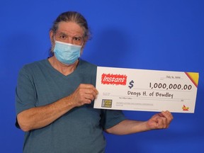Deny Haynes of Bewdley with his cheque for $1 million after his lottery win.