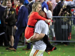 Patrick Mahomes #15 of the Kansas City Chiefs celebrates with his girlfriend, Brittany Matthews, after defeating the San Francisco 49ers 31-20 in Super Bowl LIV.