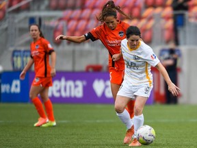 Diana Matheson #10 of Utah Royals FC battles for the ball with Shea Groom #6 of Houston Dash in the first round of the NWSL Challenge Cup at Zions Bank Stadium on June 30, 2020 in Herriman, Utah.