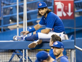 Bo Bichette sits on a dugout railing Jays instrasquad game at the Rogers Centre. Bichette and Rowdy Tellez hit home runs.