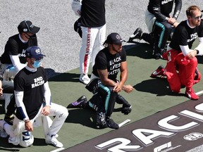 Lewis Hamilton of Great Britain and Mercedes GP, Pierre Gasly of France and Scuderia AlphaTauri and some of the F1 drivers take a knee on the grid in support of the Black Lives Matter movement ahead of the Formula One Grand Prix of Austria at Red Bull Ring on July 05, 2020 in Spielberg, Austria.