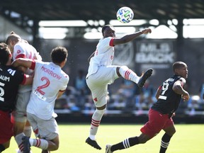Ayo Akinola #20 of Toronto FC jumps to control a corner kick in the first half during a match against D.C. United in the MLS Is Back Tournament at ESPN Wide World of Sports Complex on July 13, 2020 in Reunion, Fla.