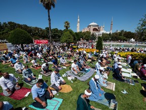Thousands of people pray during the first official Friday prayers outside Hagia Sophia Mosque on July 24, 2020 in Istanbul, Turkey. Turkey's President Recep Tayyip Erdogan attended the first Friday prayer inside the Hagia Sophia Mosque after it was officially reconverted into a mosque from a museum.
