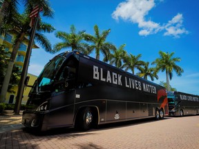 The team buses of the Toronto Raptors, with 'Black Lives Matter' displayed on the sides, arrive at the Walt Disney World complex outside Orlando on July 9.