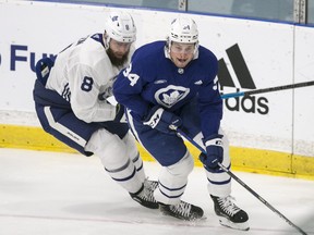 Leafs defenceman Jake Muzzin chases Auston Matthews during training camp this week.