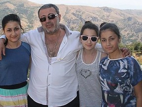 Mikhail Khachaturyan is seen in this undated photo with his three daughters who are accused of killing him.