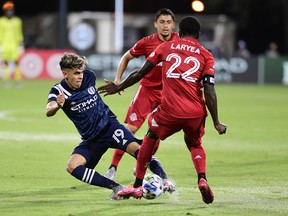 Jesus Medina (left) of New York City FC fights for the ball with Toronto FC’s Richie Laryea during their Round of 16 match last night at ESPN Wide World of Sports Complex in Reunion, Fla. TFC lost 3-1 and won’t play again until late August. Getty Images