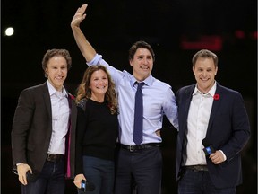 Prime Minister Justin Trudeau and his wife, Sophie, are flanked by We Day co-founders, Craig Kielburger, left, and his brother Marc, right, in front of a crowd of 16,000 people  during the We Day event at the Canadian Tire Centre in Ottawa Tuesday Nov. 10, 2015.