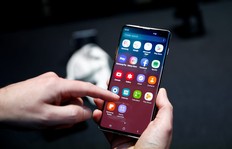 FILE PHOTO: A journalist uses the new Samsung Galaxy S10 smartphone at a press event in London