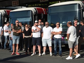 Bus drivers of the public transport network of Bayonne, southwestern France, waits for the visit of French Junior Transports Minister on July 7, 2020, a day after one of them was declared brain dead after being attacked for refusing to let aboard passengers without face masks in line with rules imposed to combat the coronavirus.