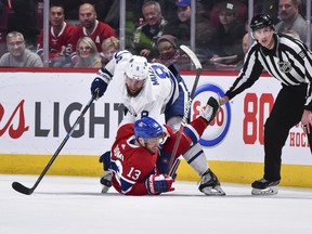 Maple Leafs defenceman Jake Muzzin (top) takes Montreal Canadiens forward Max Domi to the ice during a game in February.
