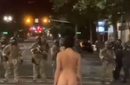 'Naked Athena' faces off with police during a Portland protest on Friday, July 17, 2020.