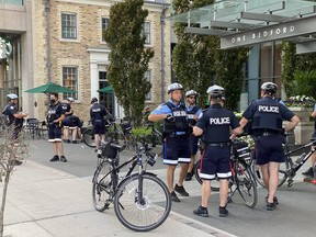 Police and special constbles outside Mayor John Tory's condo building at Bedford and Bloor Monday evening after protestors attempted to service the mayor with an 'eviction notice.'