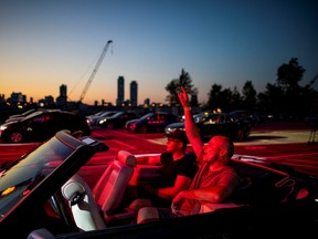 Socially-distanced music fans watch a performance by rock band Monster Truck at a drive-in concert held in a parking lot on Toronto's waterfront on Friday, July 17, 2020.