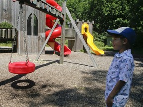 Joshua Warmington, 8, looks at a closed playground in High on Friday July 24, 2020.