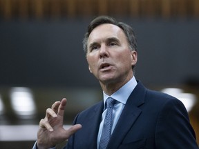 Finance Minister Bill Morneau rises in the House of Commons after delivering deliver a fiscal snapshot, Wednesday, July 8, 2020 in Ottawa.