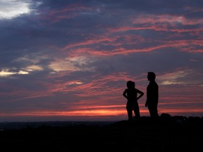 A couple watch the sunset from a park, Friday, July 3, 2020.. As the COVID-19 pandemic makes it harder for couples seeking a divorce to appear before a court, some family lawyers in Ontario say there may be more incentive for people to turn to alternative methods such as mediation.