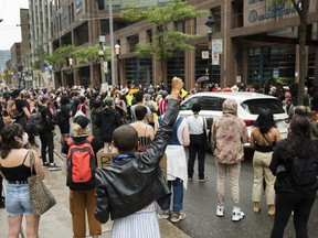 People protest to defund the police in front of Toronto Police Service headquarters, in Toronto, Thursday, July 16, 2020.