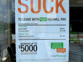 An anti-payday loans sign in Edmonton. New data had shown that eight percent of single parents in Canada borrow money at criminal interest rates.