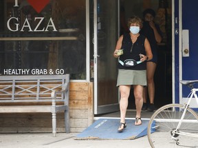 Sue-Ann Levy is ushered out of the Foodbenders store on Bloor St. W. By an unknown woman after she asked questions about their recent posting on sidewalk sandwich boards and instagram posts saying "F--- the Police " and Zionist are not allowed in the store on Friday July 3, 2020.