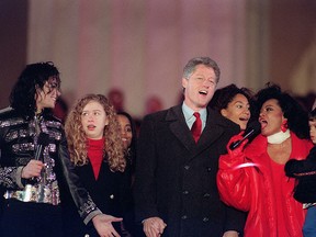 Former U.S. President Bill Clinton (second from right) and his daughter Chelsea (second from left) join singers Michael Jackson (left) and Diana Ross in the song We Are The World on Jan. 17, 1993 at the Lincoln Memorial on the Washington Mall.