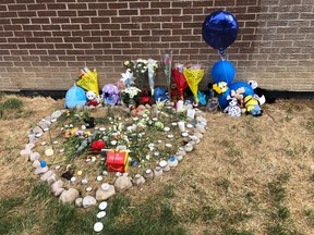 A memorial left outside the highrise on Driftwood Ave. in Toronto where a toddler fell to his death, is seen Wednesday, July 29, 2020.