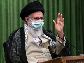 A handout picture provided by the office of Iran's Supreme Leader Ayatollah Ali Khamenei on July 12, 2020 shows him wearing a protective mask amid the COVID-19 pandemic, during a virtual meeting with lawmakers in the capital Tehran.