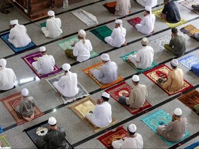 Muslim men practise social distancing as a preventive measure against the spread of COVID-19 as they take part in Friday prayers during the Islamic holy month of Ramadan at a mosque in Chana District in Songkla Province on May 8, 2020.