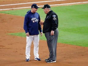 Manager AJ Hinch of the Houston Astros talks with umpire Joe West during Game 4 of the American League Championship Series at Minute Maid Park on October 17, 2018 in Houston.