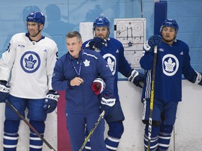 Maple Leafs head coach Sheldon Keefe (centre) runs drills at training camp on Tuesday.