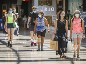Shoppers wearing masks at are seen in Toronto, on July 7, the first day of a mandatory mask or face covering bylaw.