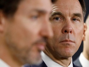 Canada's Minister of Finance, Bill Morneau, looks at Prime Minister Justin Trudeau during a press conference in Ottawa March 11, 2020.