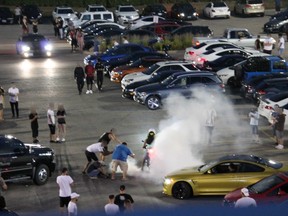 York Regional Police officers observed a motorcycle doing a burnout in the crowded parking lot while people stood nearby filming the stunt.