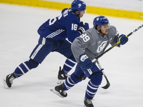 Nick Robertson (right) and Mitch Marner head up-ice at Maple Leafs practice on Wednesday.