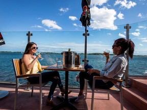 Crystal Holder (left) and Heidi Coughlan enjoy a drink at Amsterdam Brewhouse's patio in Toronto June 24, 2020.