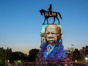 The image of late Rep. John Lewis, a pioneer of the civil rights movement and long-time member of the U.S. House of Representatives, is projected on the statue of Confederate General Robert E. Lee in Richmond, Virginia, U.S. July 19, 2020.