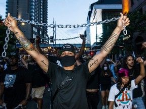 Demonstrators carry chains during the Black 4th protest in downtown Minneapolis on July 4, 2020.