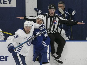 Nick Robertson (right) is watched by closely Kyle Clifford at Maple Leafs practice on Tuesday. Notice the referee? Officials were a new addition at practice and will be going forward.