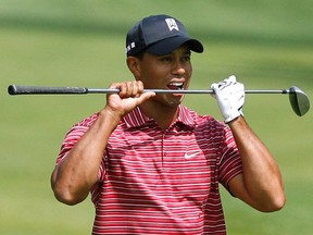 FILE PHOTO: ON THIS DAY -- June 7 June 7, 2009 GOLF - Tiger Woods bites his club after his second shot on the 11th hole during his Memorial Tournament win at Muirfield Village Golf Club in Dublin, Ohio. Woods came from four strokes behind to seal his 67th PGA Tour victory with a dramatic birdie-birdie finish. He won the tournament for a record fourth time with a 12-under total of 276, finishing ahead of fellow American Jim Furyk who rolled in a 22-foot birdie putt at the 18th for a 69. REUTERS/Matt Sullivan/File Photo ORG XMIT: AI