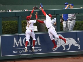 Neither Washington Nationals centre fielder Victor Robles (right) nor left fielder Emilio Bonifacio are able to catch the ball hit for a home run hit by Toronto Blue Jays DH Vladimir Guerrero Jr. during the second inning on July 28, 2020, at Nationals Park.