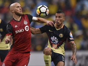 Toronto FC’s Michael Bradley (left) battles for possession of the ball with Club America’s Mateus Uribe during the second leg of their Concacaf Champions League semifinal on April 10, 2018, at Azteca Stadium in Mexico City.