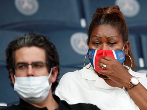 Fans wear protective face masks at a soccer game at Parc des Princes, Paris, on Fri. July 17, 2020.