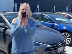A woman is seen throwing a tantrum after being asked by security to move her car from a parking space reserved for electric vehicles at Sherway Gardens.